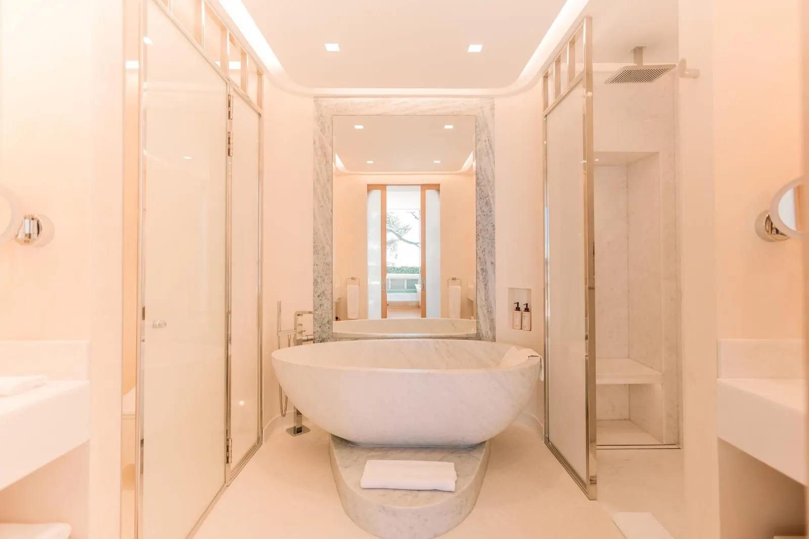 Surrenne Suite at The Maybourne Riviera: the bathroom with a freestanding stone bath between glass partitions