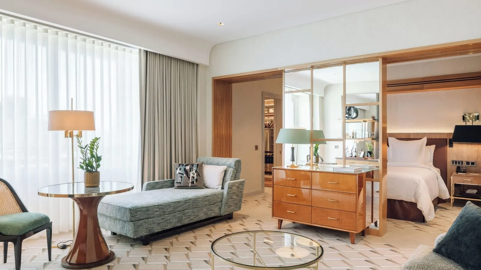 Studio Suite at Four Seasons Ritz Lisbon: a daybed and round table in the alcove, with the bed beyond a mirrored screen