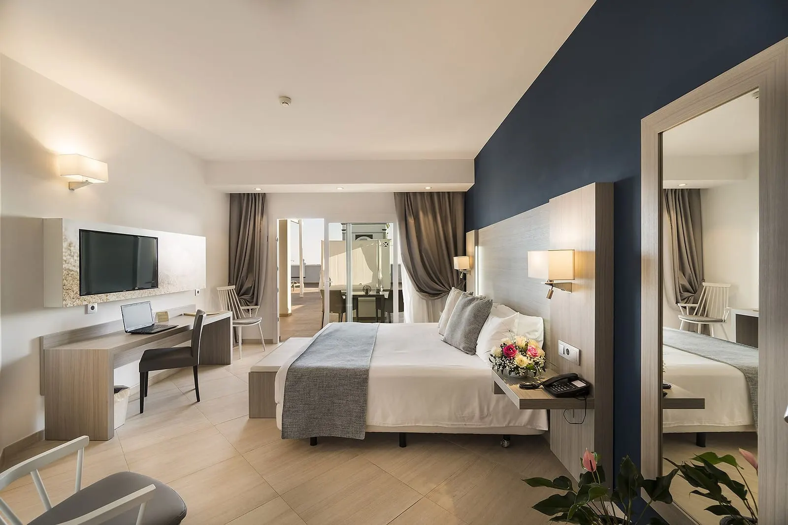 Presidential Suite at Royal Palm Resort & Spa: a large bedroom with a double bed, a desk, a wall-mounted television and a tall mirror