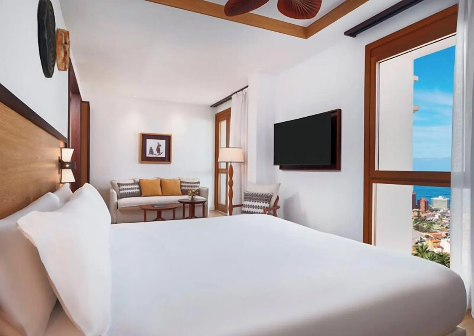 2 Bedroom Presidential Suite with Balcony Panoramic View at Gran Hotel Taoro: a bed, a sofa and a window onto the town
