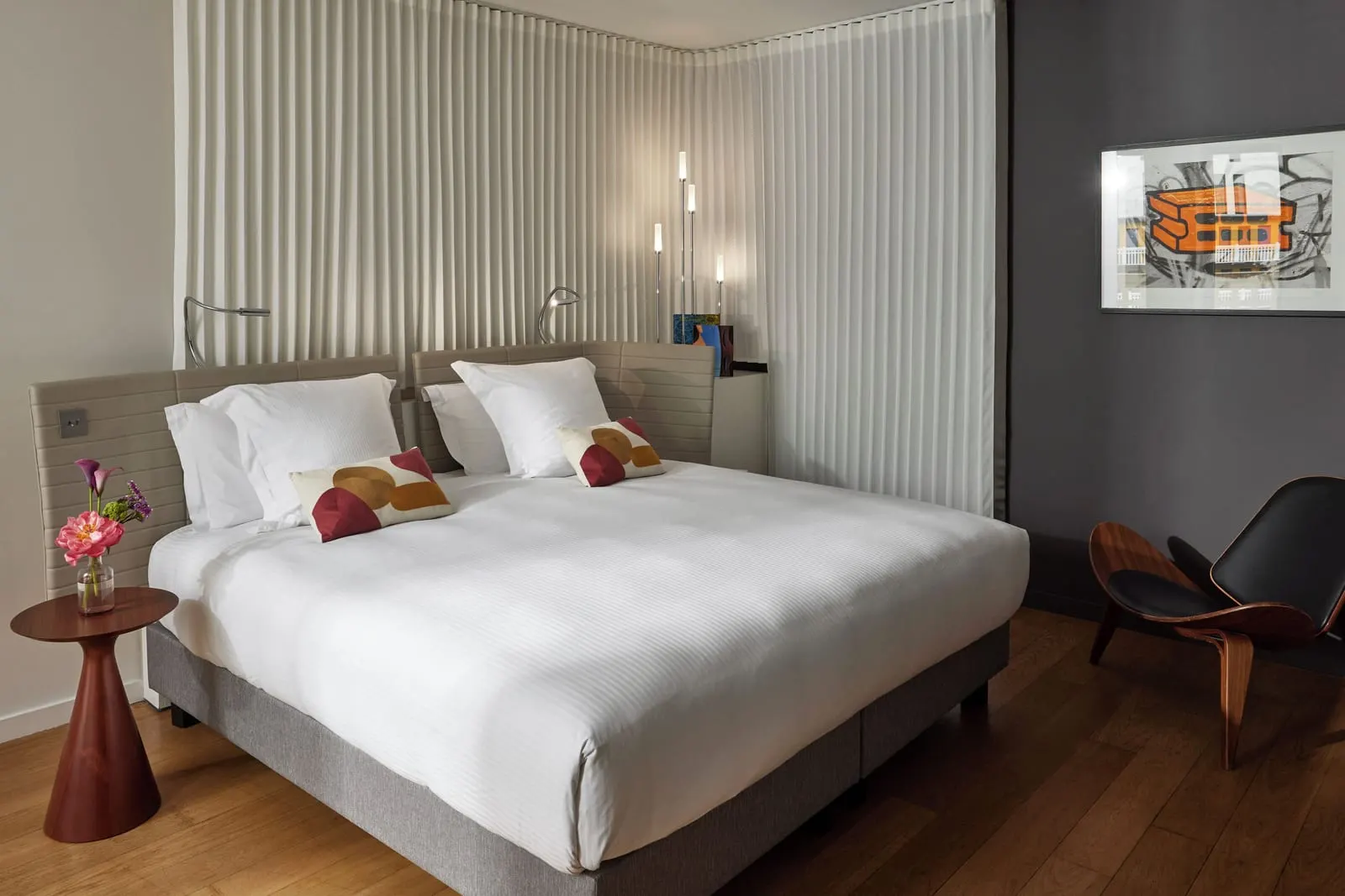 Pool Suite at Hôtel Molitor Paris: a king-size bed with patterned cushions, a wooden side table and a curved wooden armchair