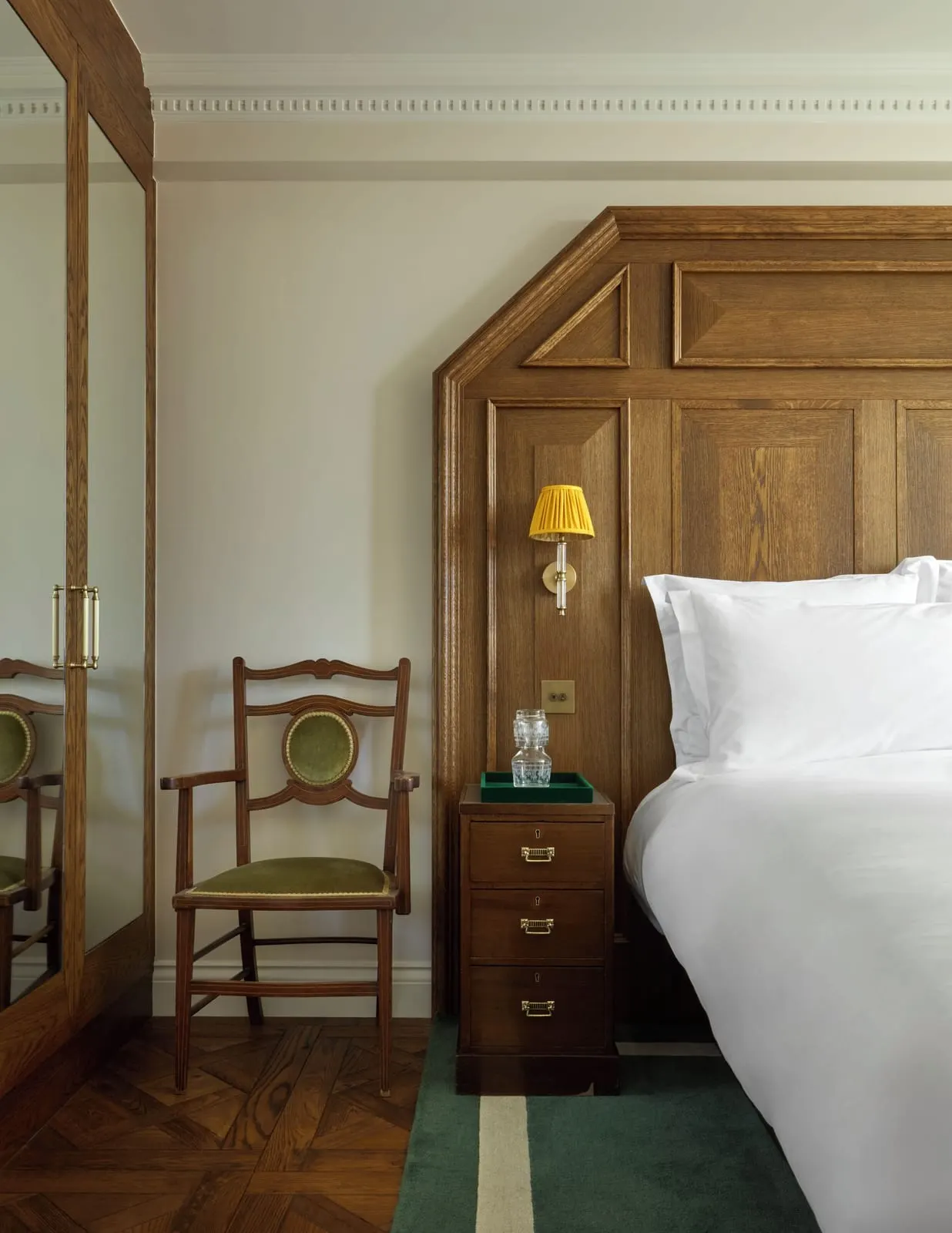 Edwardian Cabin Suite at Sea Containers London: the bed, a panelled wooden wall, a chest of drawers and a chair