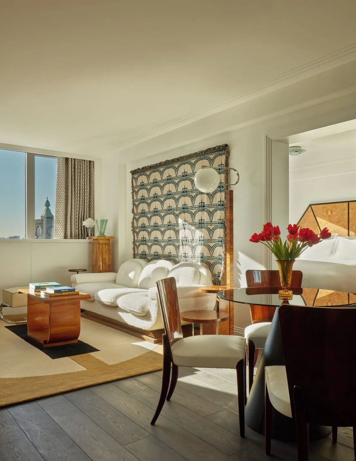 Art Deco Cabin Suite at Sea Containers London: the living area with a white sofa, a dining table and a patterned wall