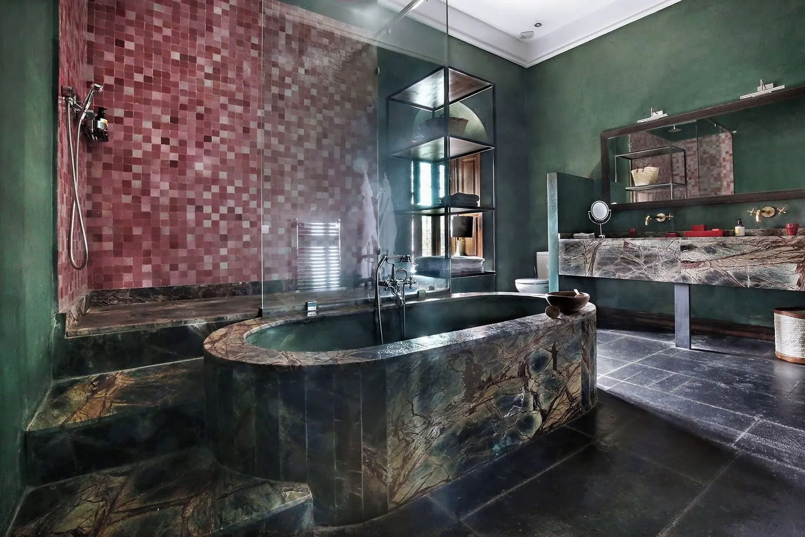 Medium Room at El Fenn: a bathroom with a large stone bath, a pink tiled shower wall and a marble double basin