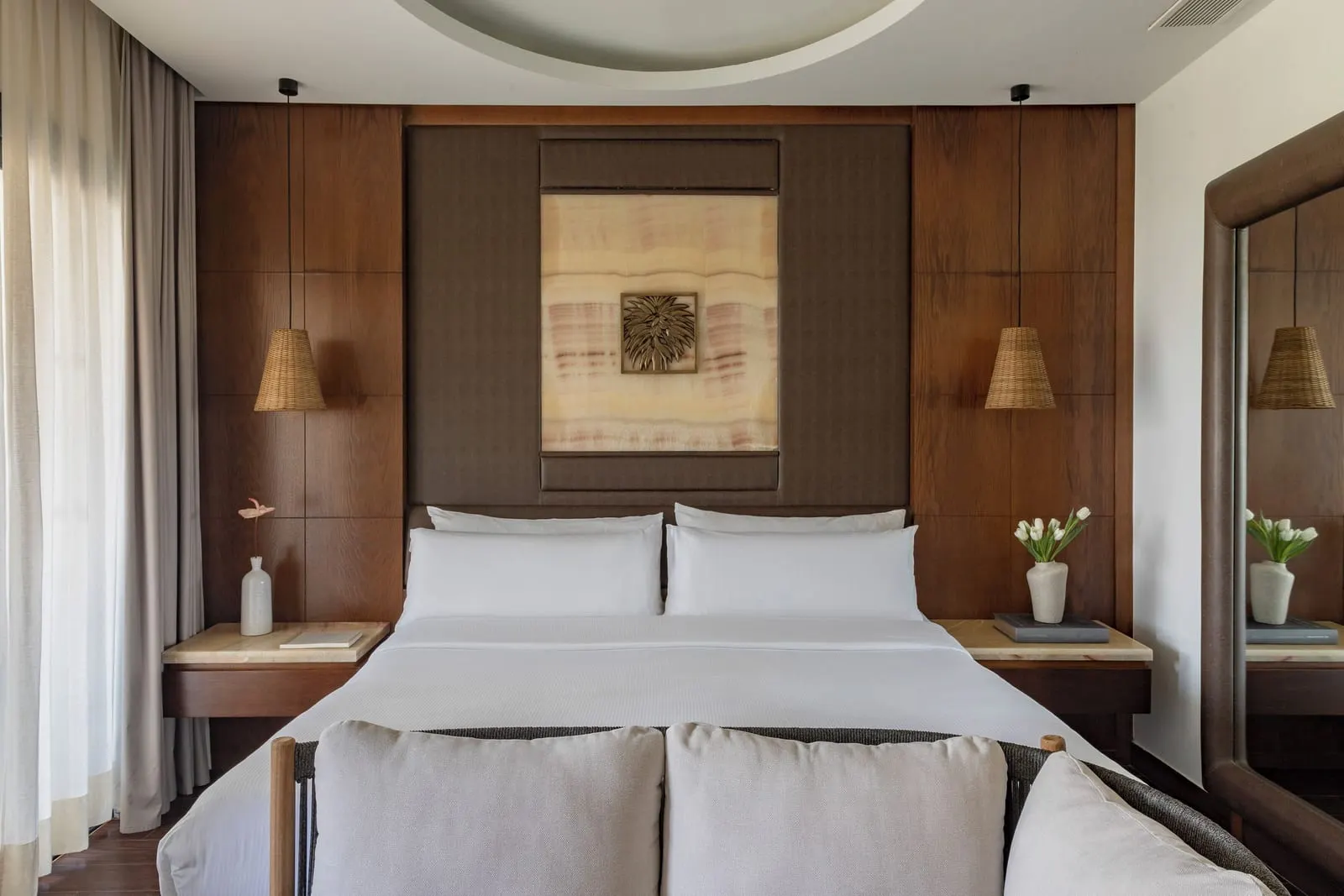 Deluxe Room at Gran Meliá Palacio de Isora: a king bed against a wood-panelled wall, with rattan lamps