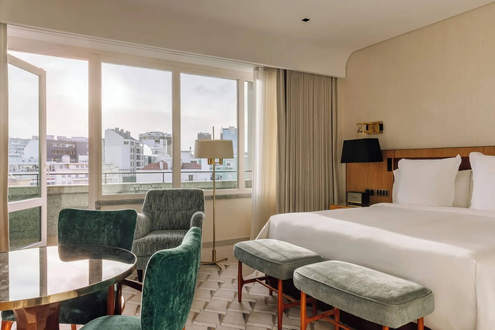 Premier Riverside-View Room at Four Seasons Ritz Lisbon: the bed, green velvet armchairs and a wide window over the city