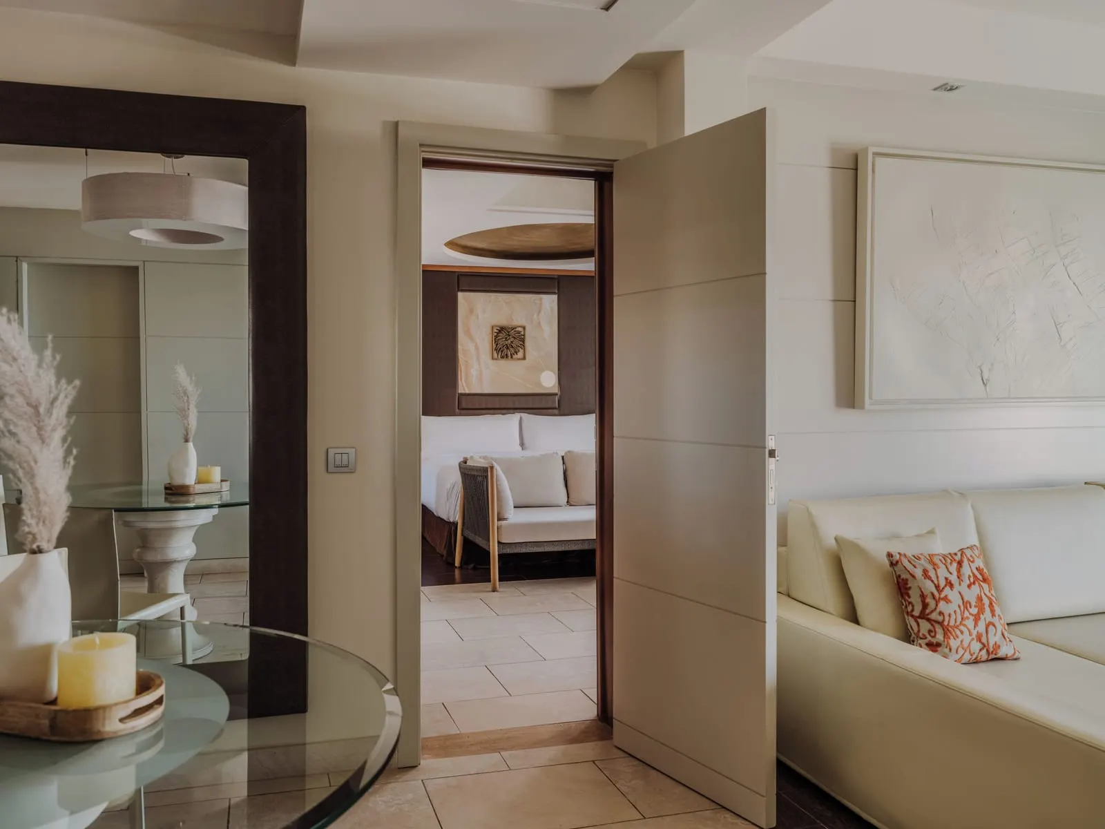Master Suite Two Bedrooms at Gran Meliá Palacio de Isora: a dining table and sofa, a door open to a bedroom