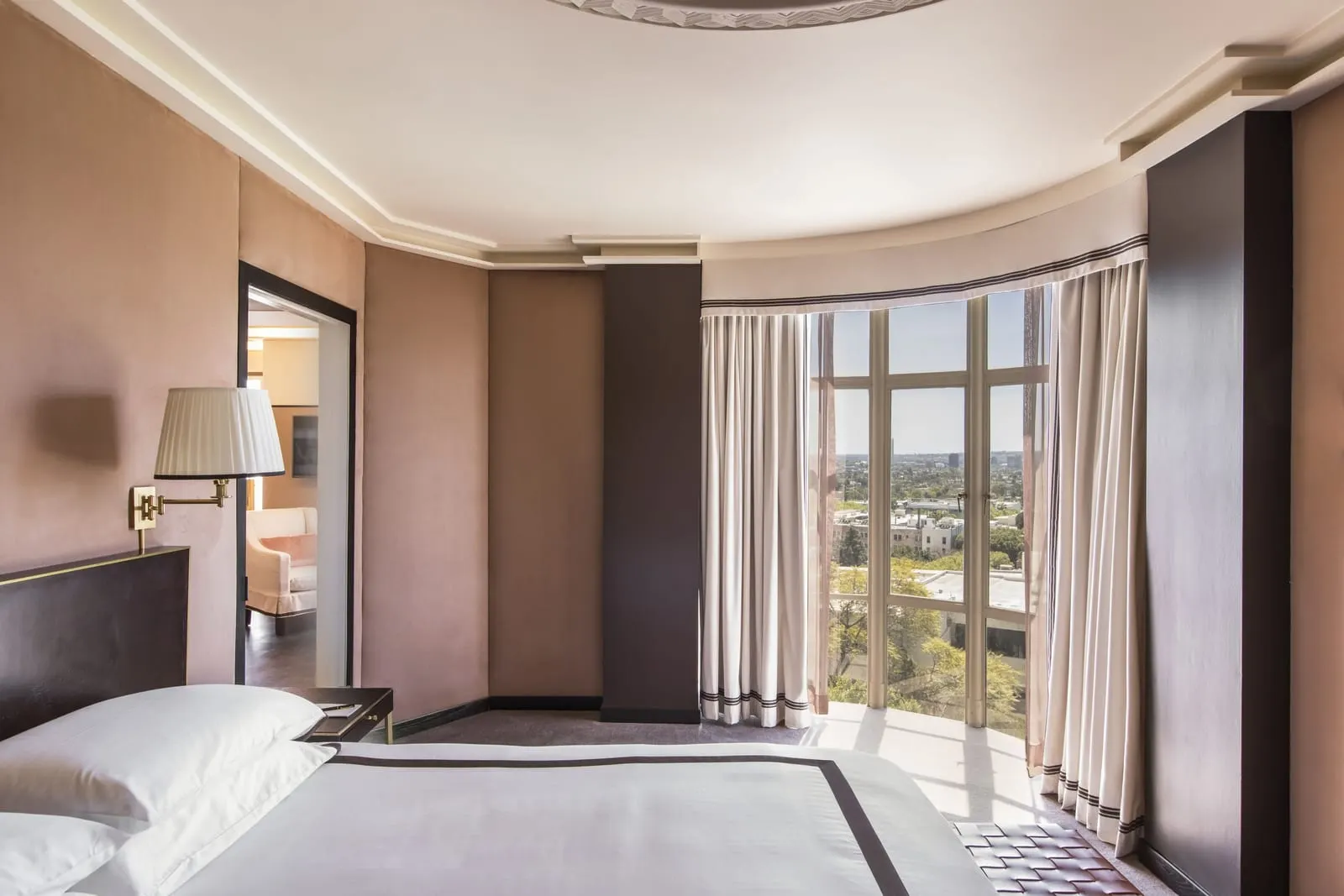 Sunset Tower Hotel: A suite bedroom with a curved wall of windows