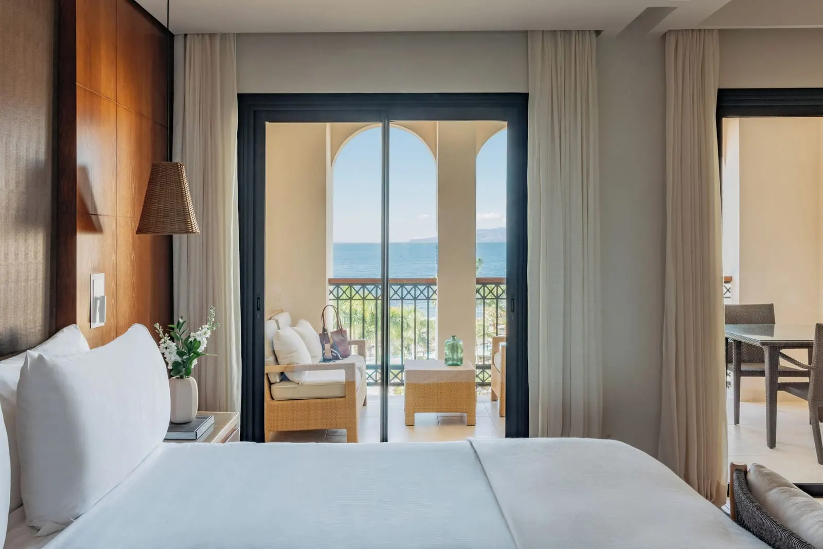 RedLevel Junior Suite Ocean Front at Gran Meliá Palacio de Isora: the bed facing balcony doors, arches and the sea