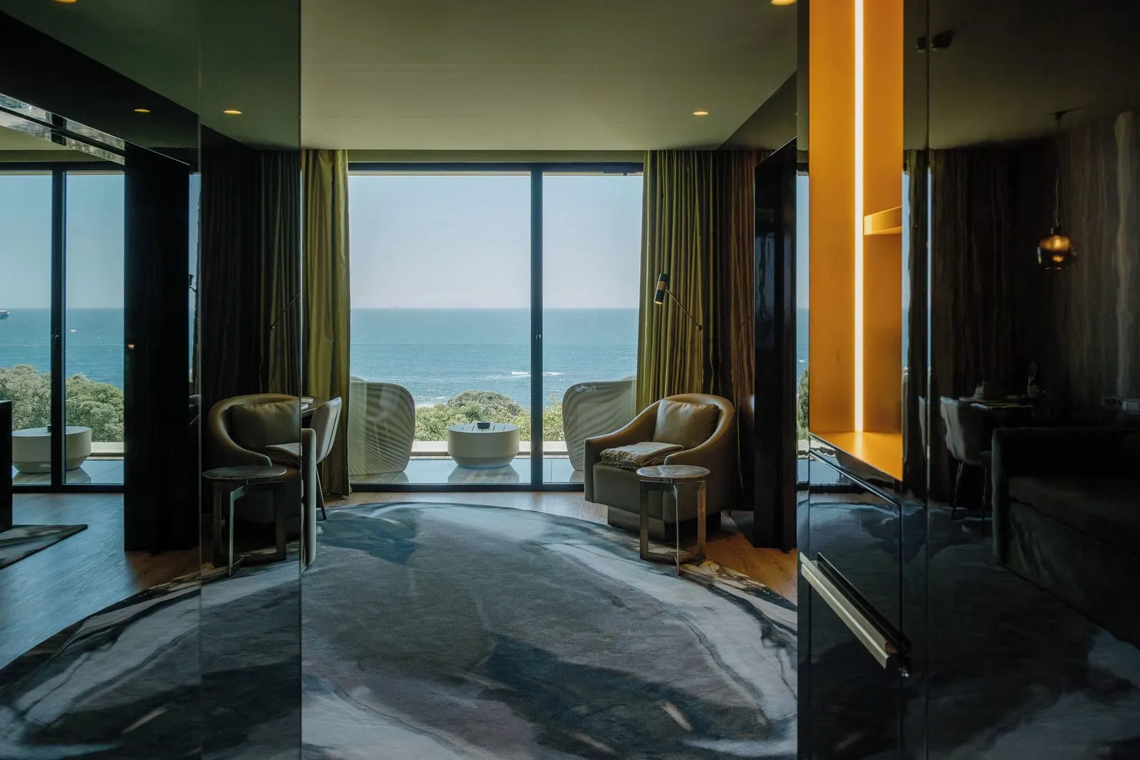 Onice Sea View Suite at Vila Foz: the sitting area with armchairs and glass doors to a balcony over the sea