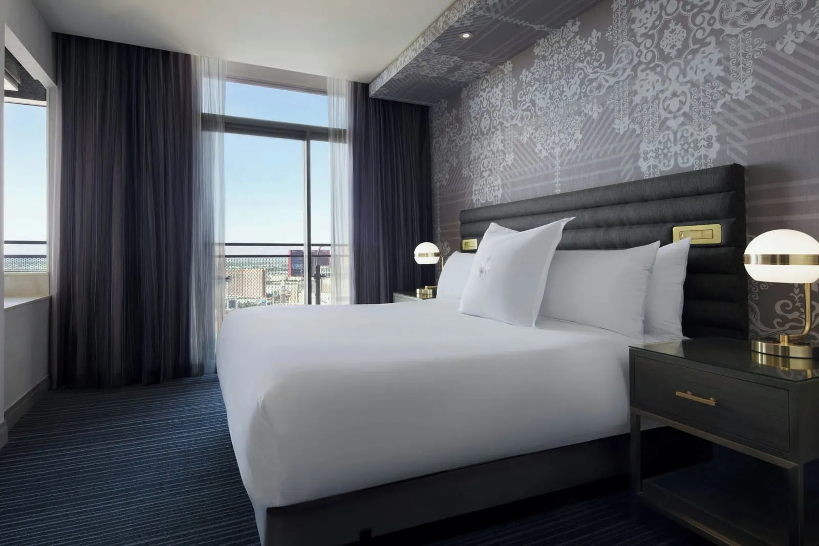 Terrace One Bedroom Suite Fountain View at The Cosmopolitan of Las Vegas: the bedroom, with a king bed, a brass globe lamp on each bedside table and full-height glass doors