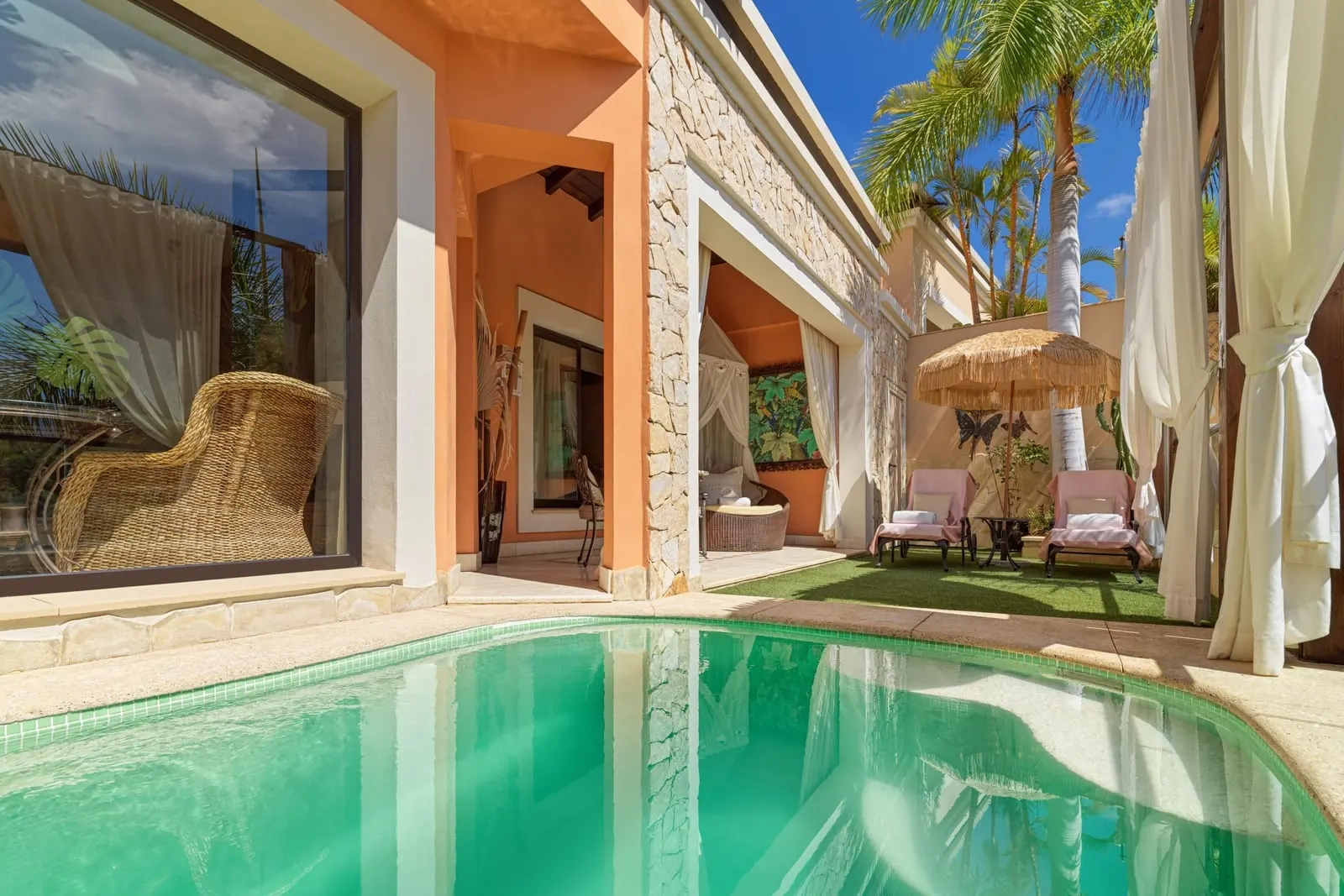 Duchess Villa at Royal Garden Villas: the private pool beside the villa, with loungers and a parasol on the lawn