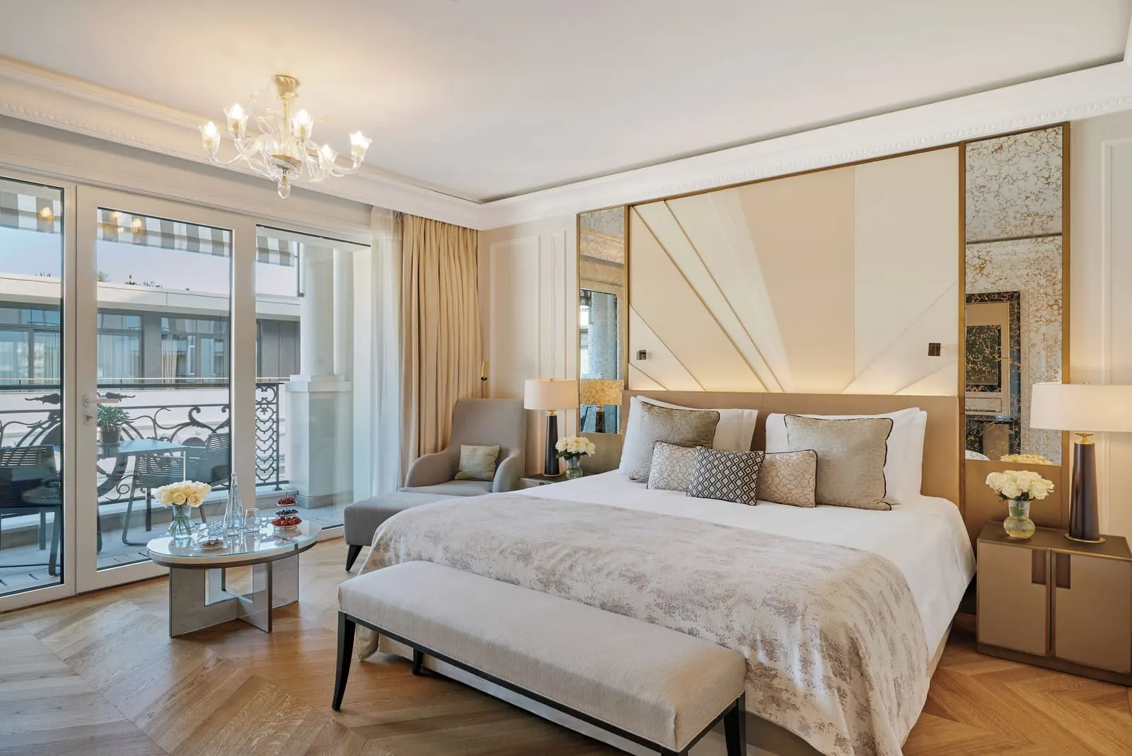 Prestige Room with patio view at Hôtel de Paris Monte-Carlo: the bed with a bench, an armchair and glass doors to the balcony