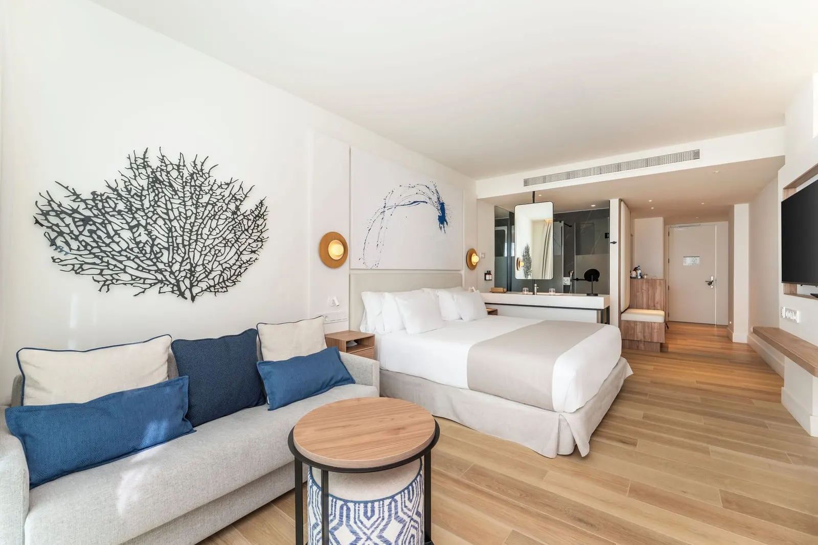Superior Sea Front at Barceló Playa Blanca: a king bed with a sofa and coffee table, and the bathroom opening off the room