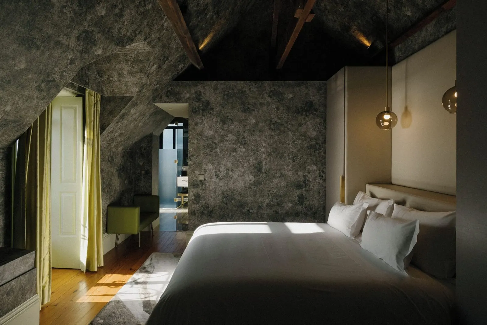 Manor House Ocean Front Suite at Vila Foz: the attic bedroom with timber beams, the bed and a shuttered window