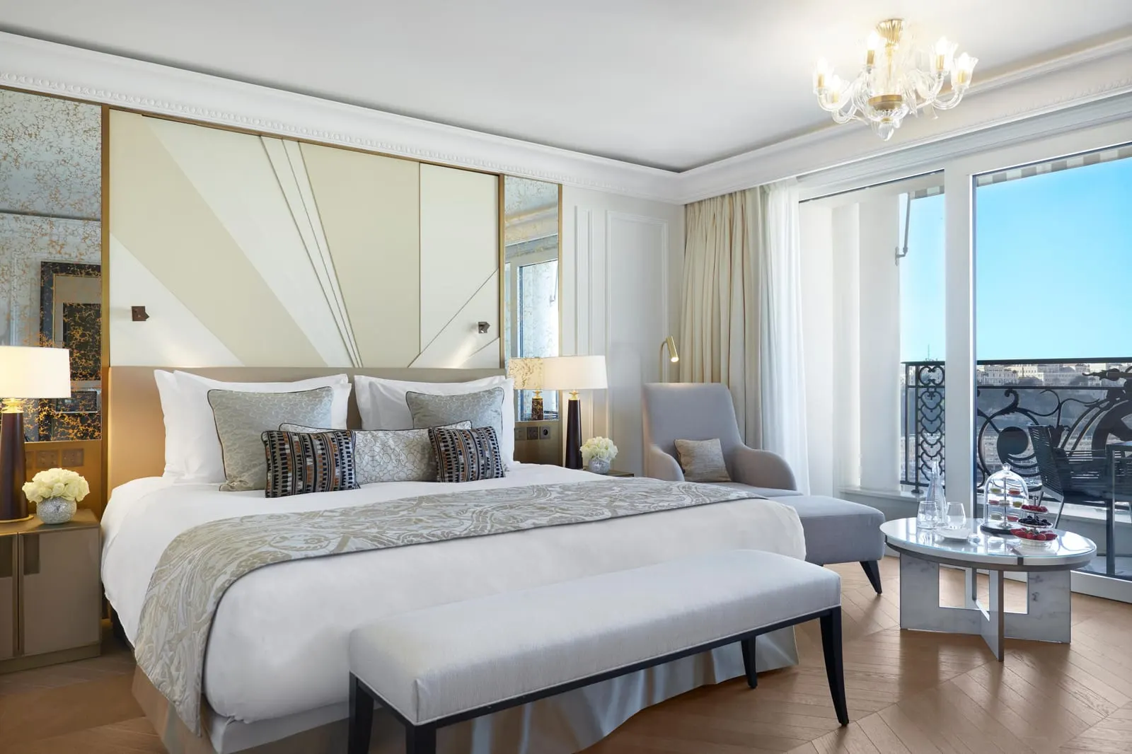 Exclusive Room with sea view and terrace at Hôtel de Paris Monte-Carlo: the bed, an armchair and glass doors to the terrace