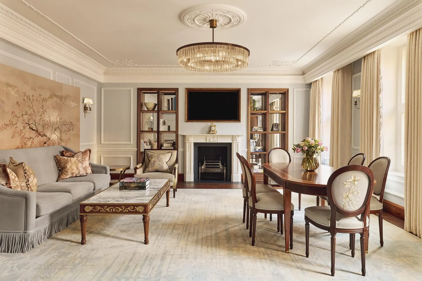Brook Suite at Claridge's: the living room with a fireplace, a chandelier and an oval dining table