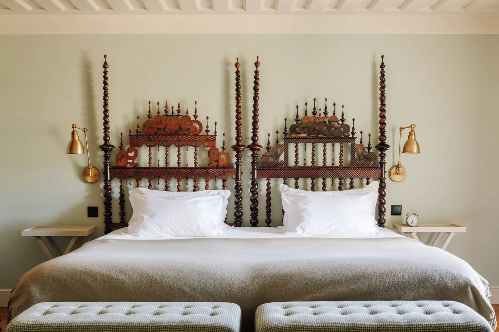 Premium Manor House Accommodation at Quinta Nova with twin beds under carved wooden headboards and brass wall lamps