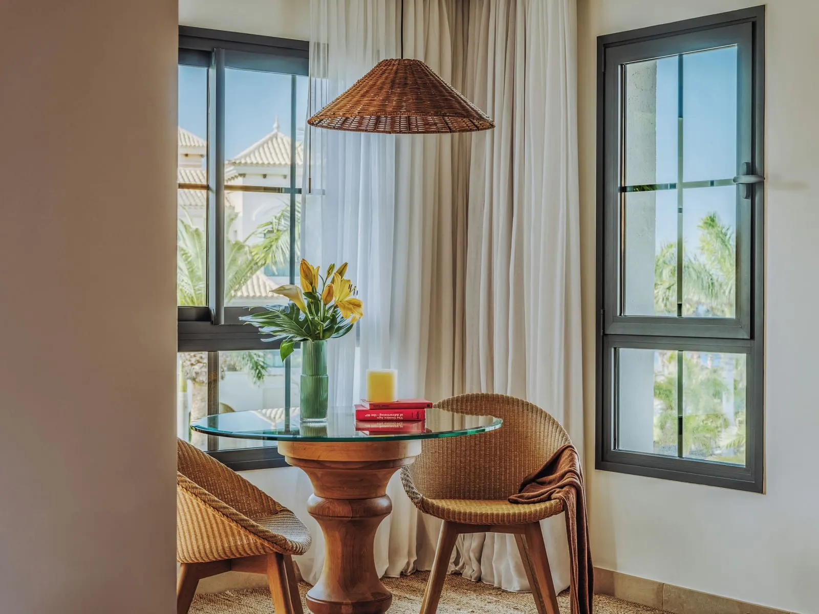 RedLevel Junior Suite Ocean Partial View and Whirlpool at Gran Meliá Palacio de Isora: a table and wicker chairs by the windows