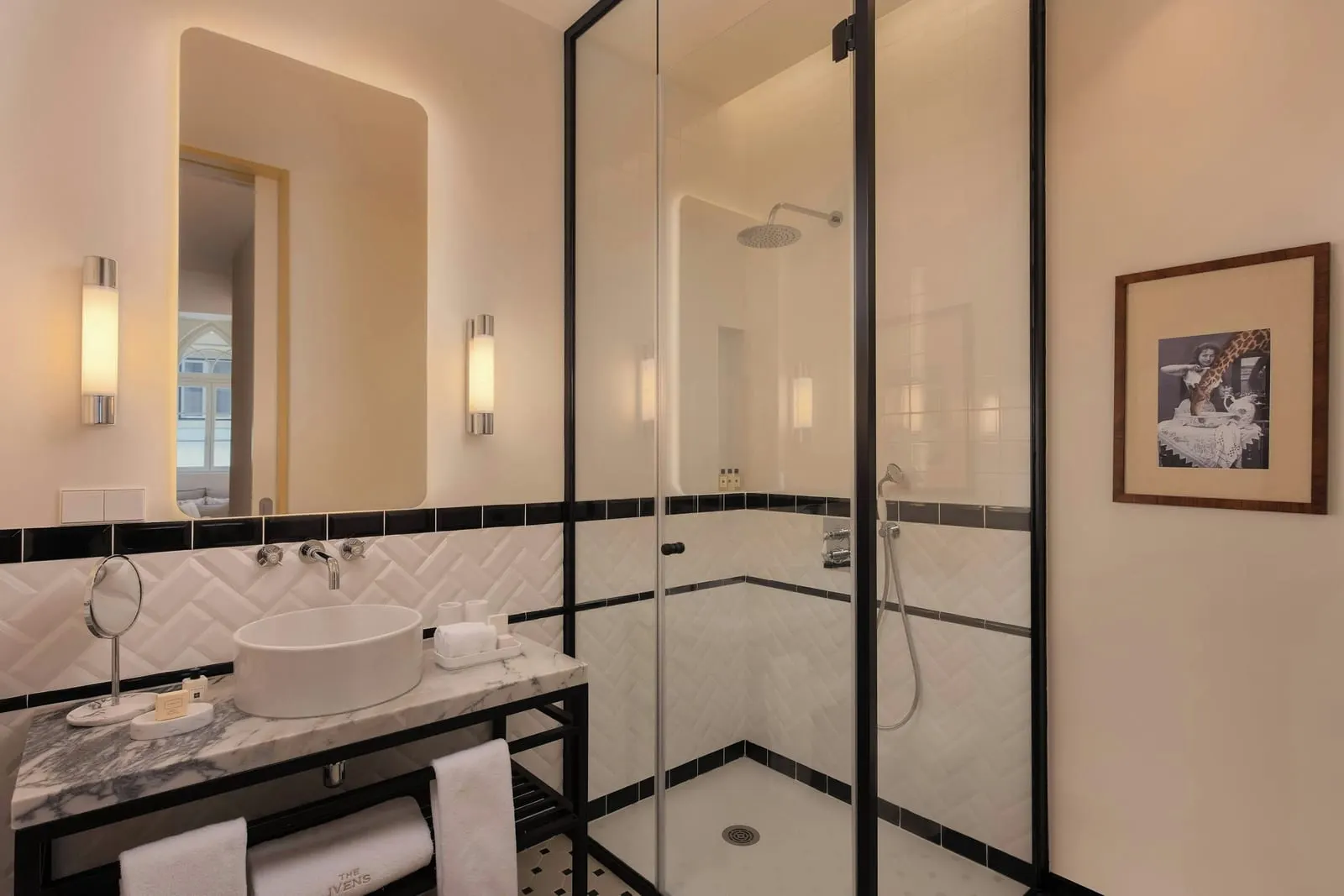 Ivens Balcony bathroom at The Ivens: a bowl basin on a marble stand and a glass-walled shower