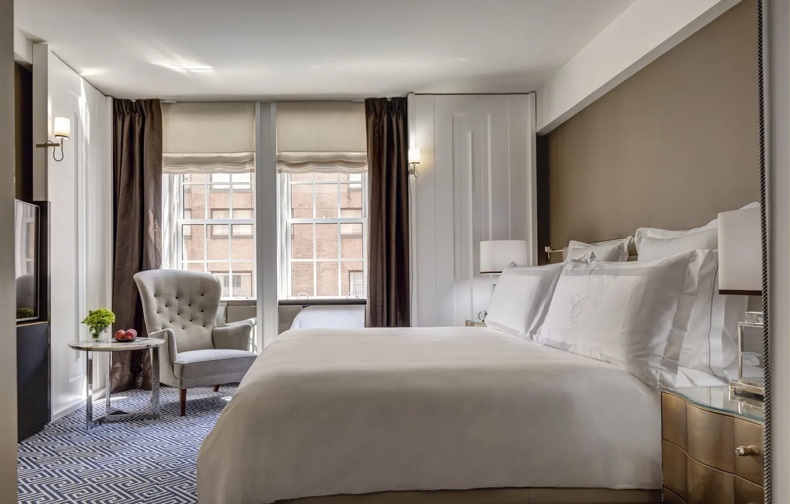 Premier Two-Bedroom Suite at The Carlyle: a king bed with white linen, an armchair and two tall windows