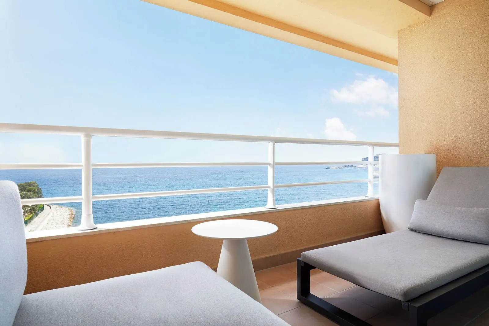 Horizon Suite at Le Méridien Beach Plaza: the balcony with a lounger and a round table facing the sea