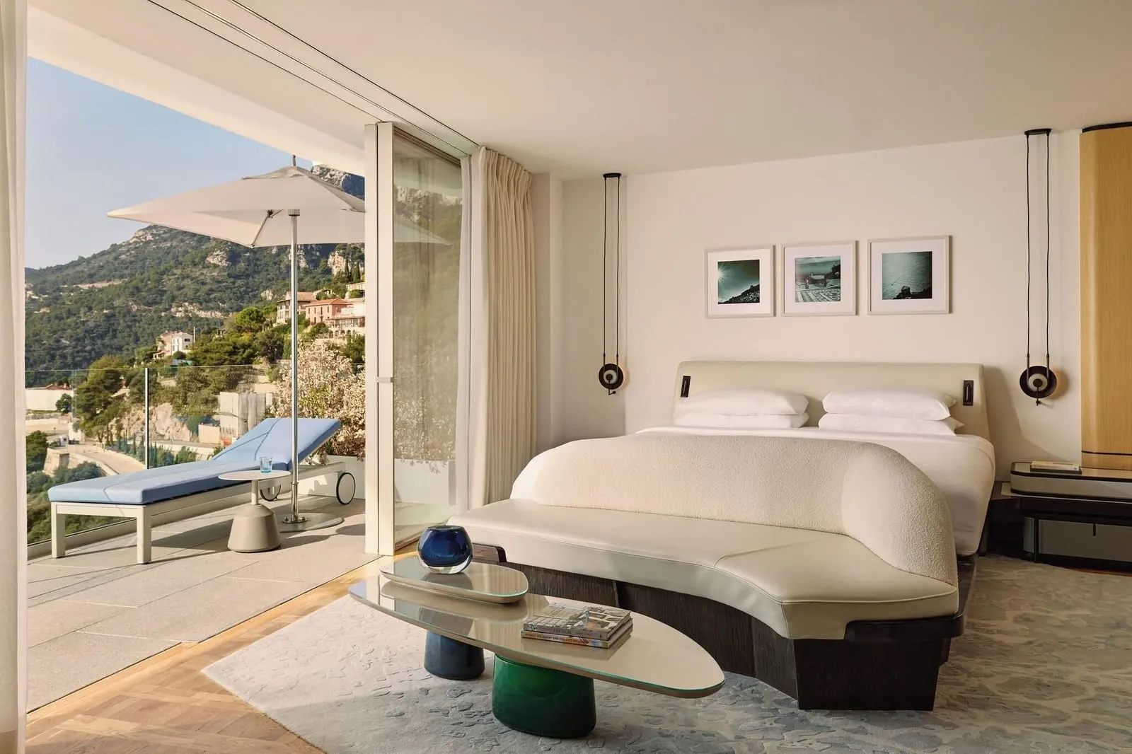 Panoramic Sea View Studio at The Maybourne Riviera: the bed, a low table and glass doors open to the terrace and a lounger