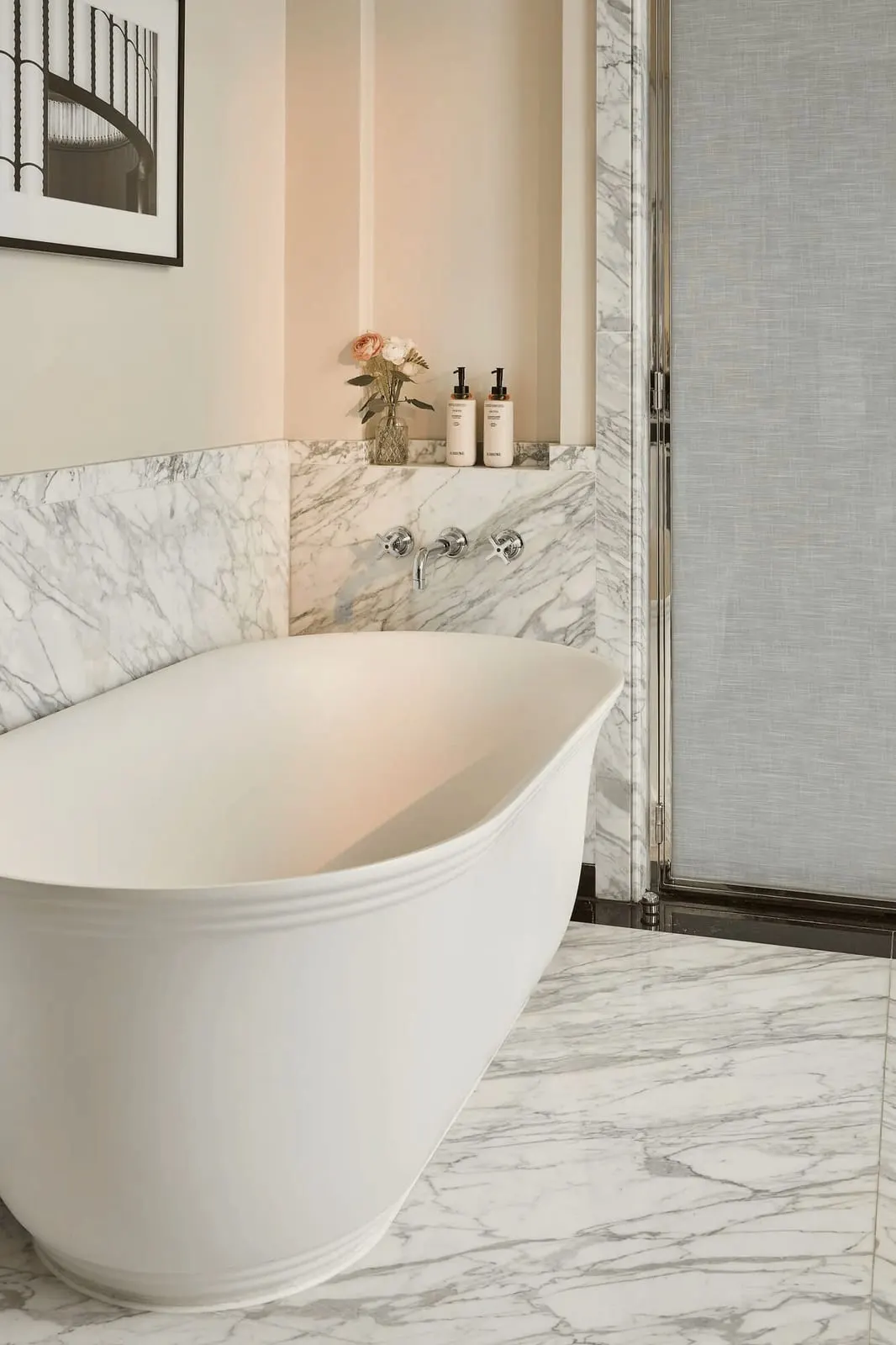 Mayfair Balcony Room bathroom at Claridge's: a freestanding bath against a marble wall