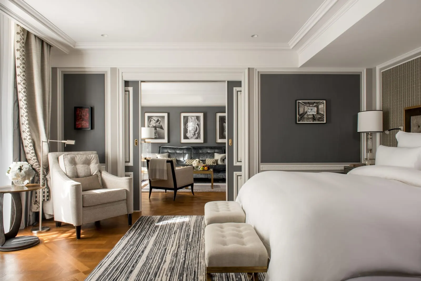 Grand Premier Suite at Hôtel de Crillon, A Rosewood Hotel: the bedroom, with an armchair by the window and an open double doorway onto the lounge and its velvet sofa
