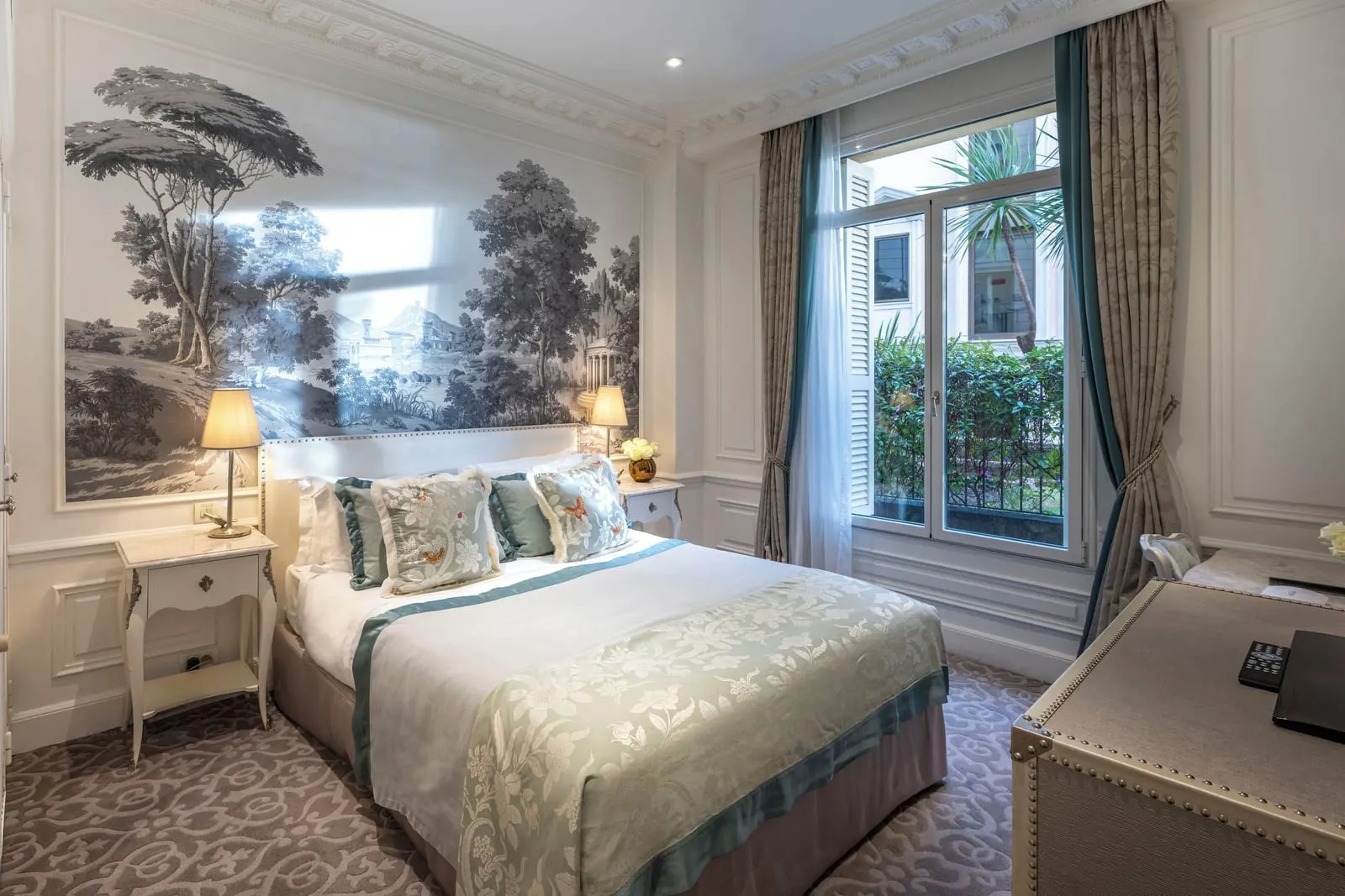Superior Queen Room at Hôtel Hermitage Monte-Carlo: the bed below a landscape mural, with a window onto greenery