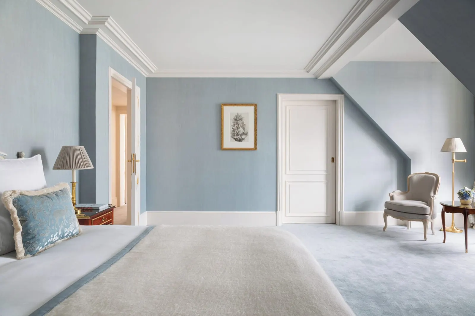 Suite Honeymoon at Le Bristol Paris: the bedroom under a sloping ceiling, with pale blue walls, an armchair and a floor lamp