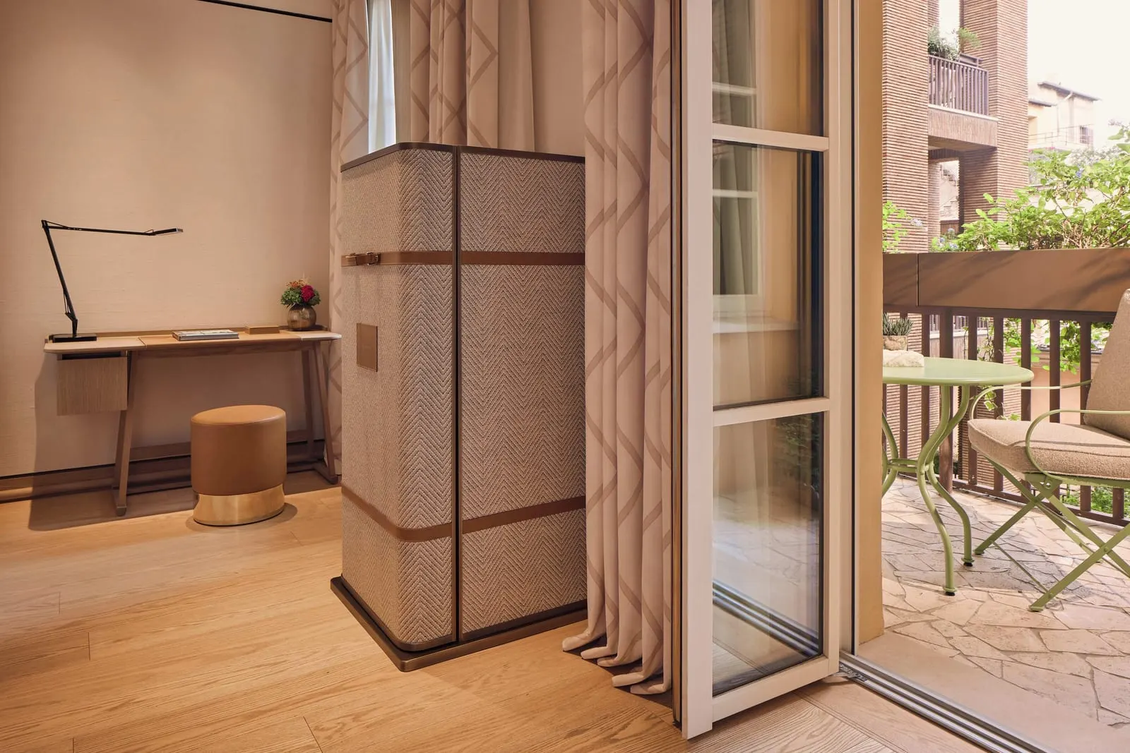 Premium Room at Bvlgari Hotel Roma: a writing desk and glass doors open onto a balcony with a table and chairs