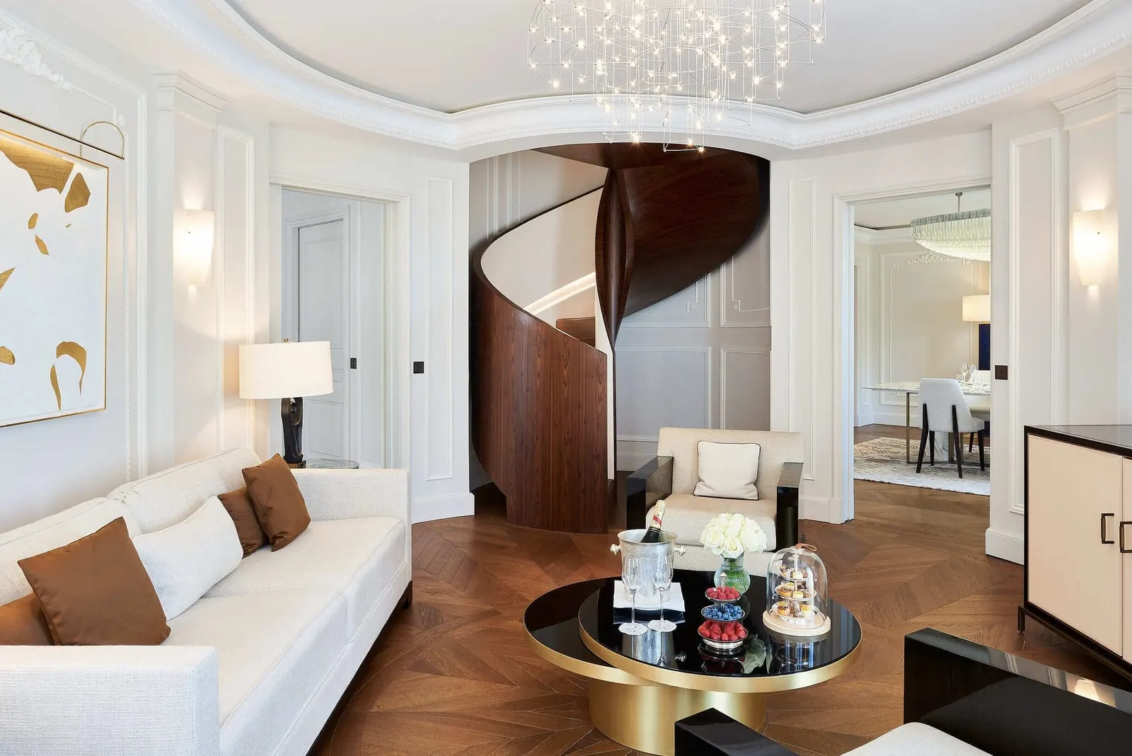 Deluxe Suite with city view at Hôtel de Paris Monte-Carlo: the lounge with a white sofa and a spiral staircase
