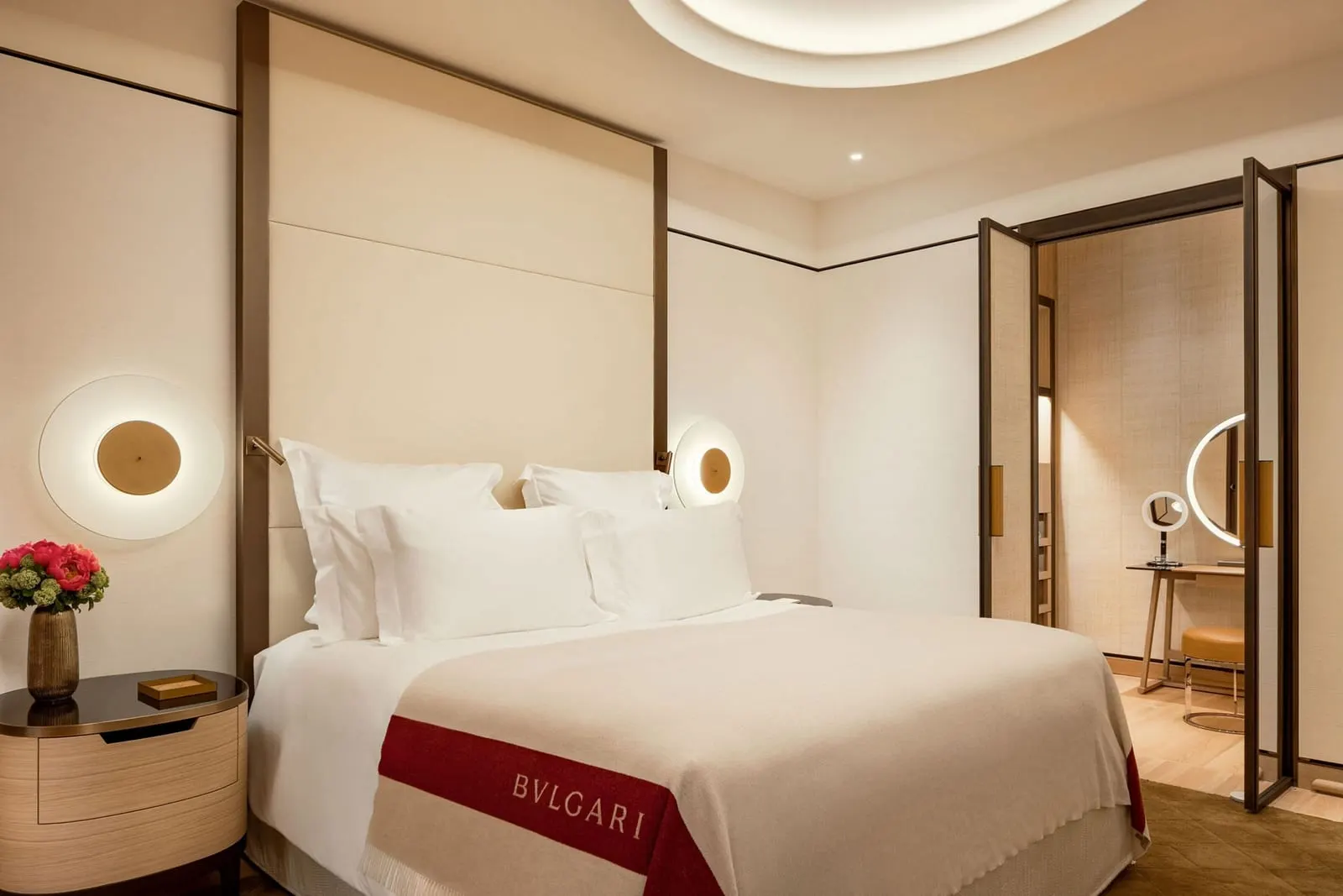 Premium Room at Bvlgari Hotel Roma: a double bed with a branded throw and open doors to a dressing area