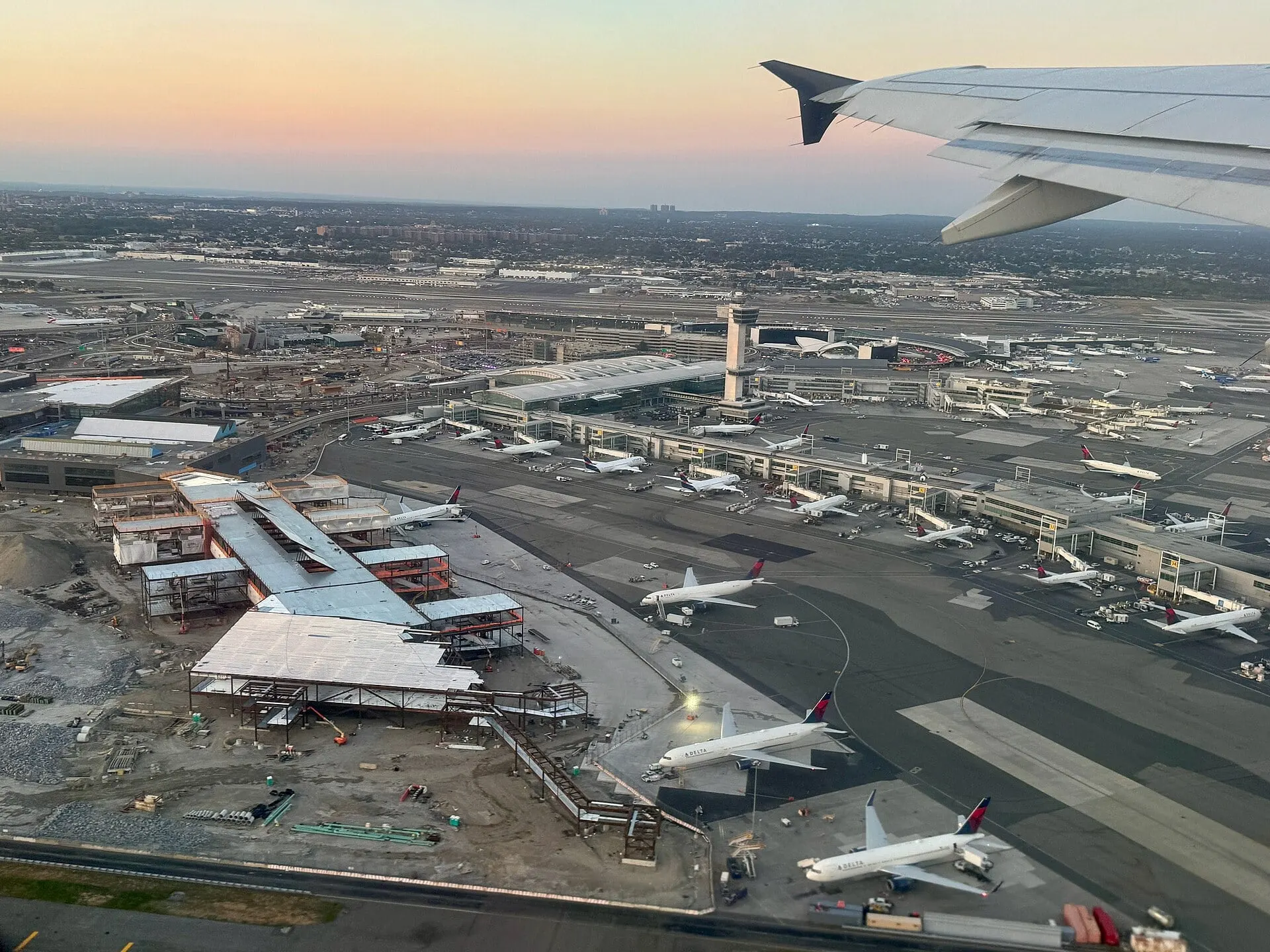 Terminal 4 and its gates at JFK seen from a departing aircraft at dusk