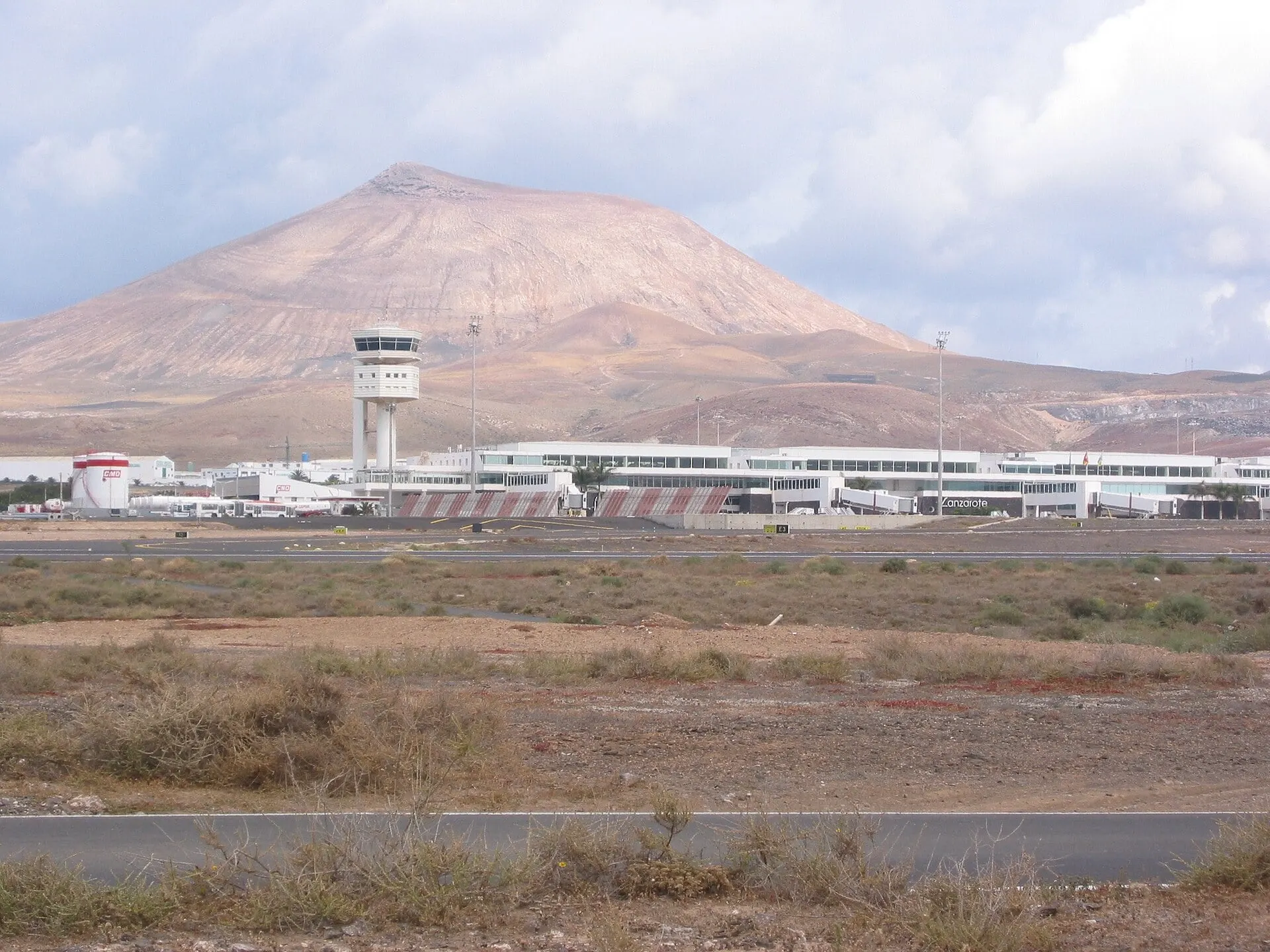 The terminal and control tower at Lanzarote Airport, with a volcanic hill behind