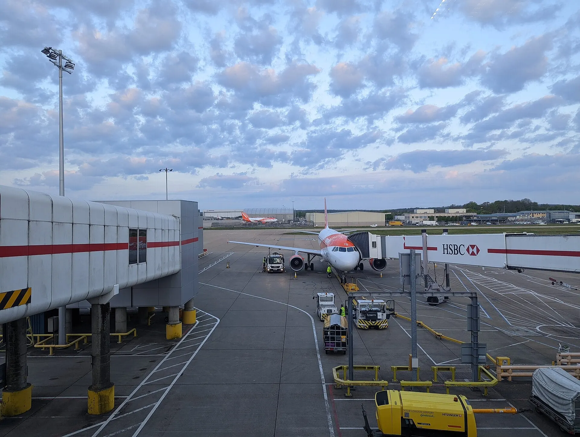 An easyJet Airbus at a jet bridge on stand at Gatwick North Terminal