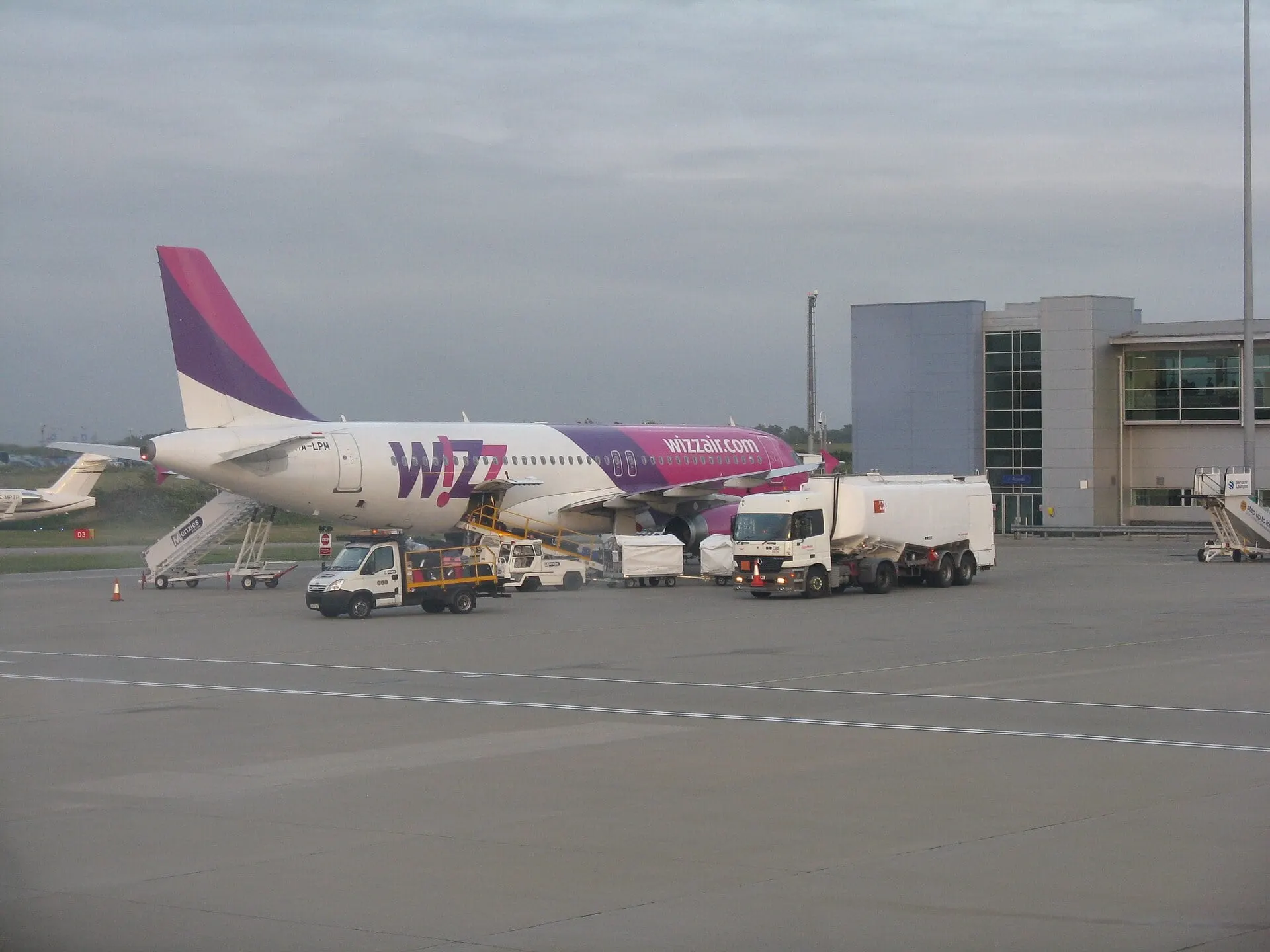 A Wizz Air Airbus on stand at London Luton Airport