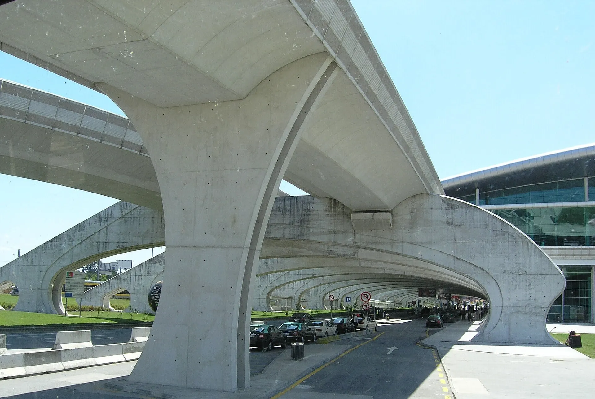 The curved concrete metro viaduct sweeping over the forecourt road at Porto Airport