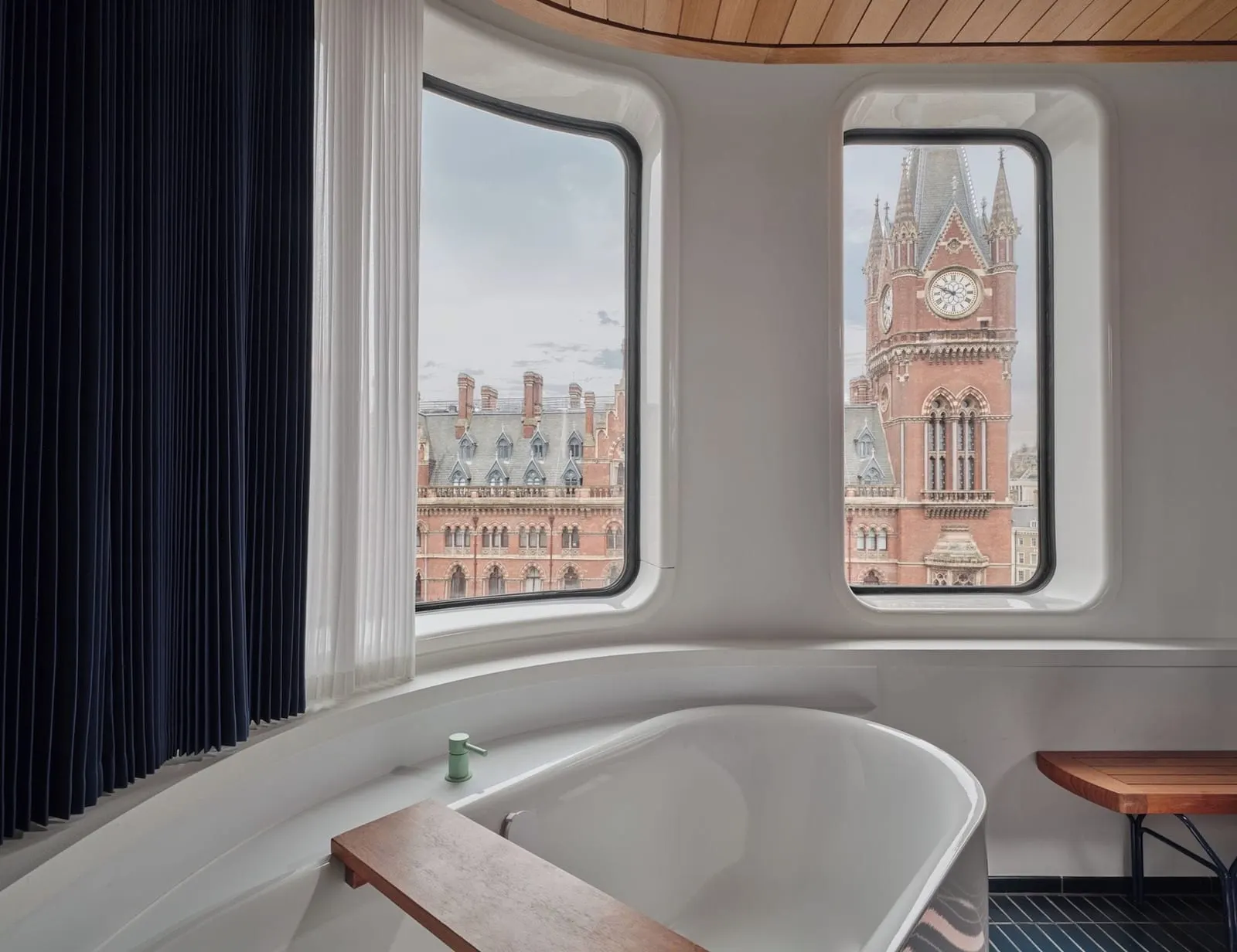 Premium King View at The Standard, London: a bath below round-cornered windows onto the St Pancras clock tower