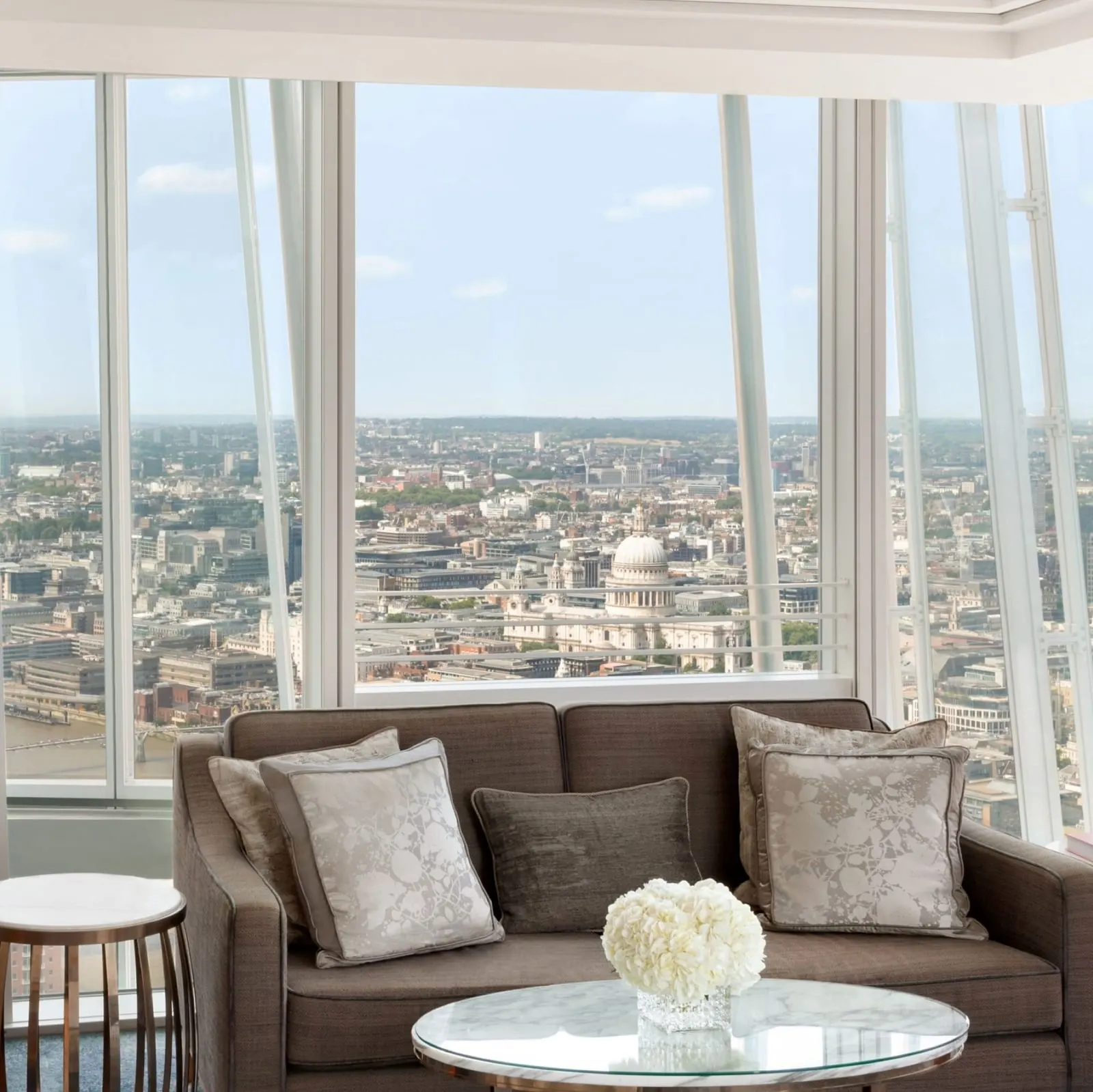 Iconic City View Room at Shangri-La The Shard: a sofa by the window, with the dome of St Paul's Cathedral in the view
