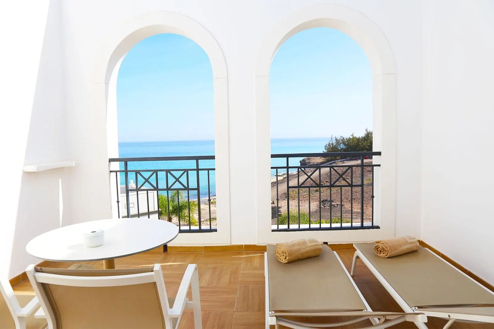 Double Sea View Superior at Royal Palm Resort & Spa: two sun loungers and a small table on a balcony with arched openings looking out to the sea