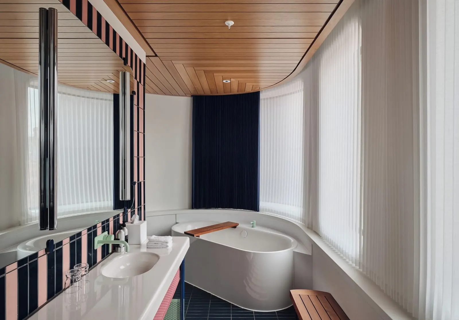 Premium King View bathroom at The Standard, London: a long basin counter and a bath under a wood-slatted ceiling