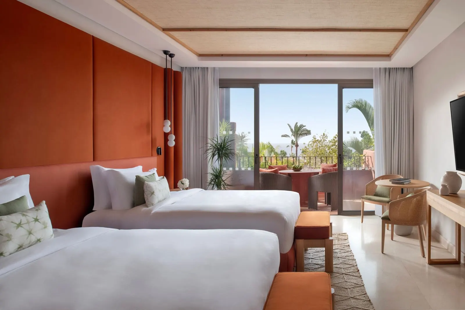 Retreat Deluxe Family Room Ocean View at the Ritz-Carlton Abama: two double beds, a desk and doors to the terrace