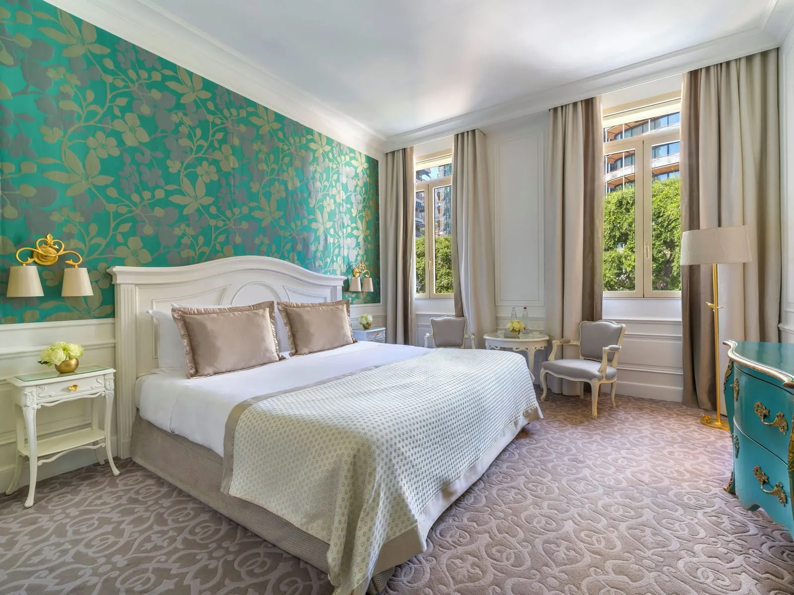 Deluxe Room with city or courtyard view at Hôtel Hermitage Monte-Carlo: the bed against green floral wallpaper, armchairs by the window