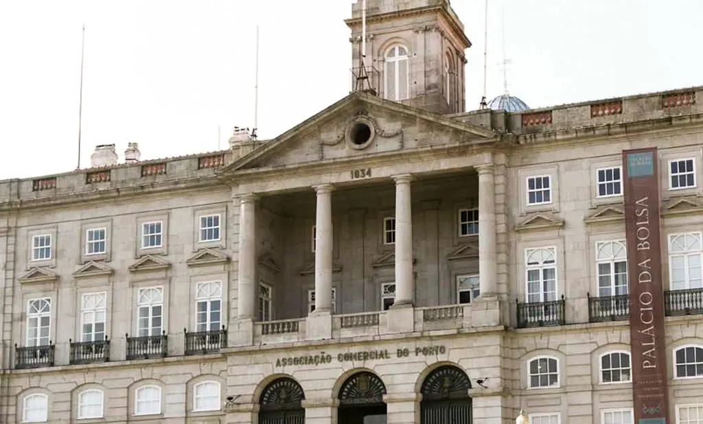The neoclassical front of the Palácio da Bolsa in Porto, with its columned portico and clock