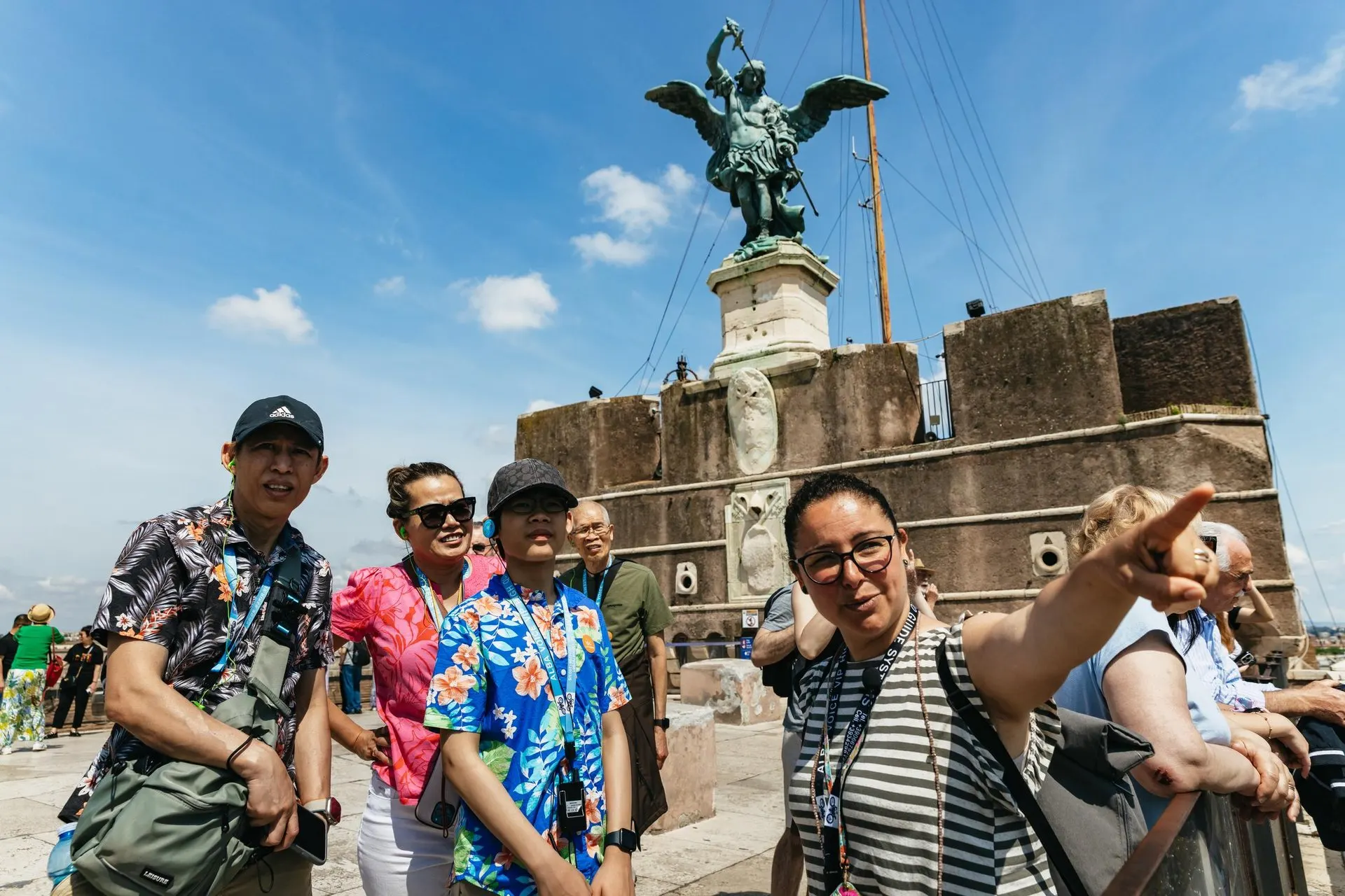 A guide pointing out the view to a group on the terrace of Castel Sant'Angelo