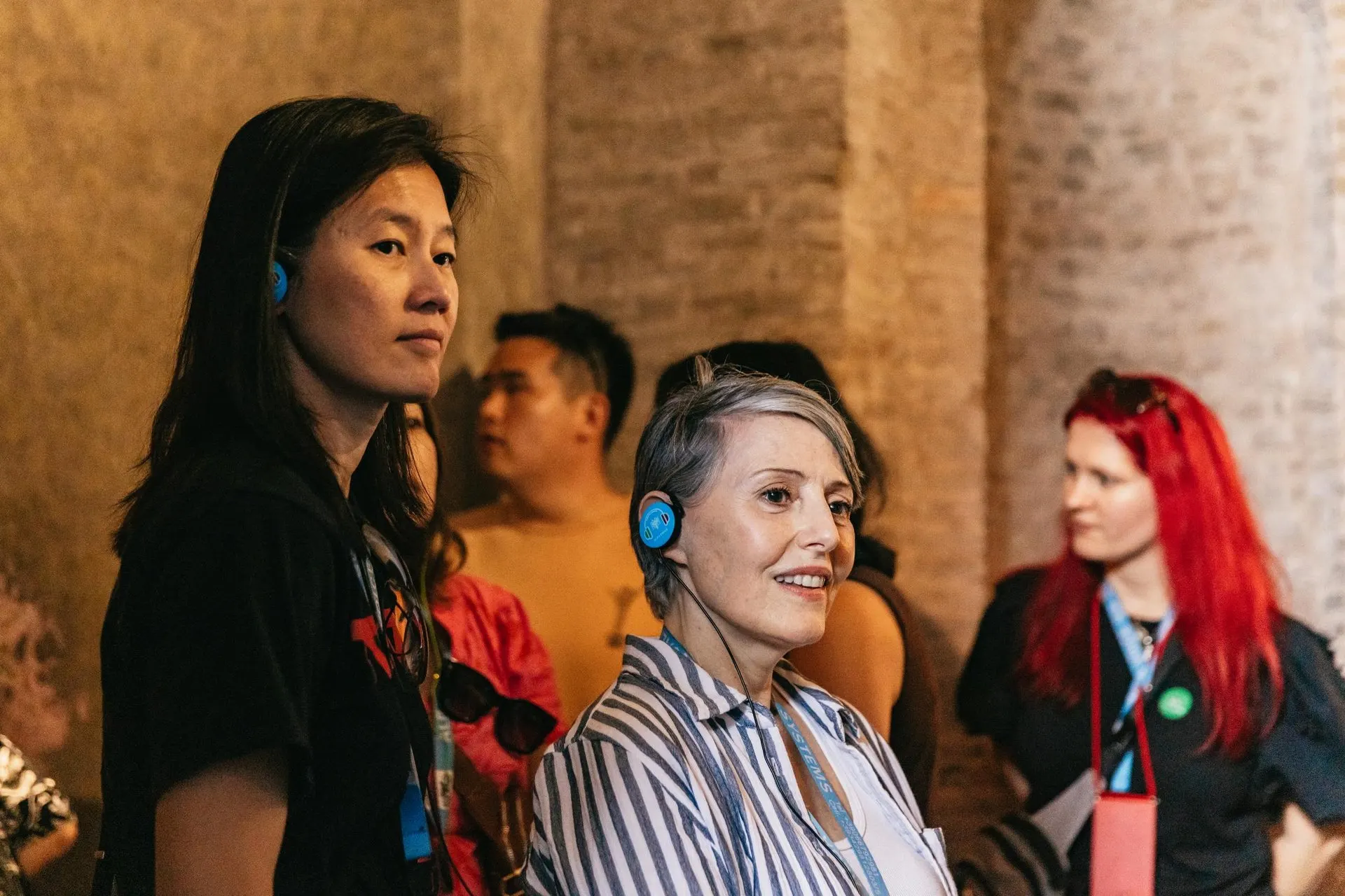 Visitors with headsets listening to their guide