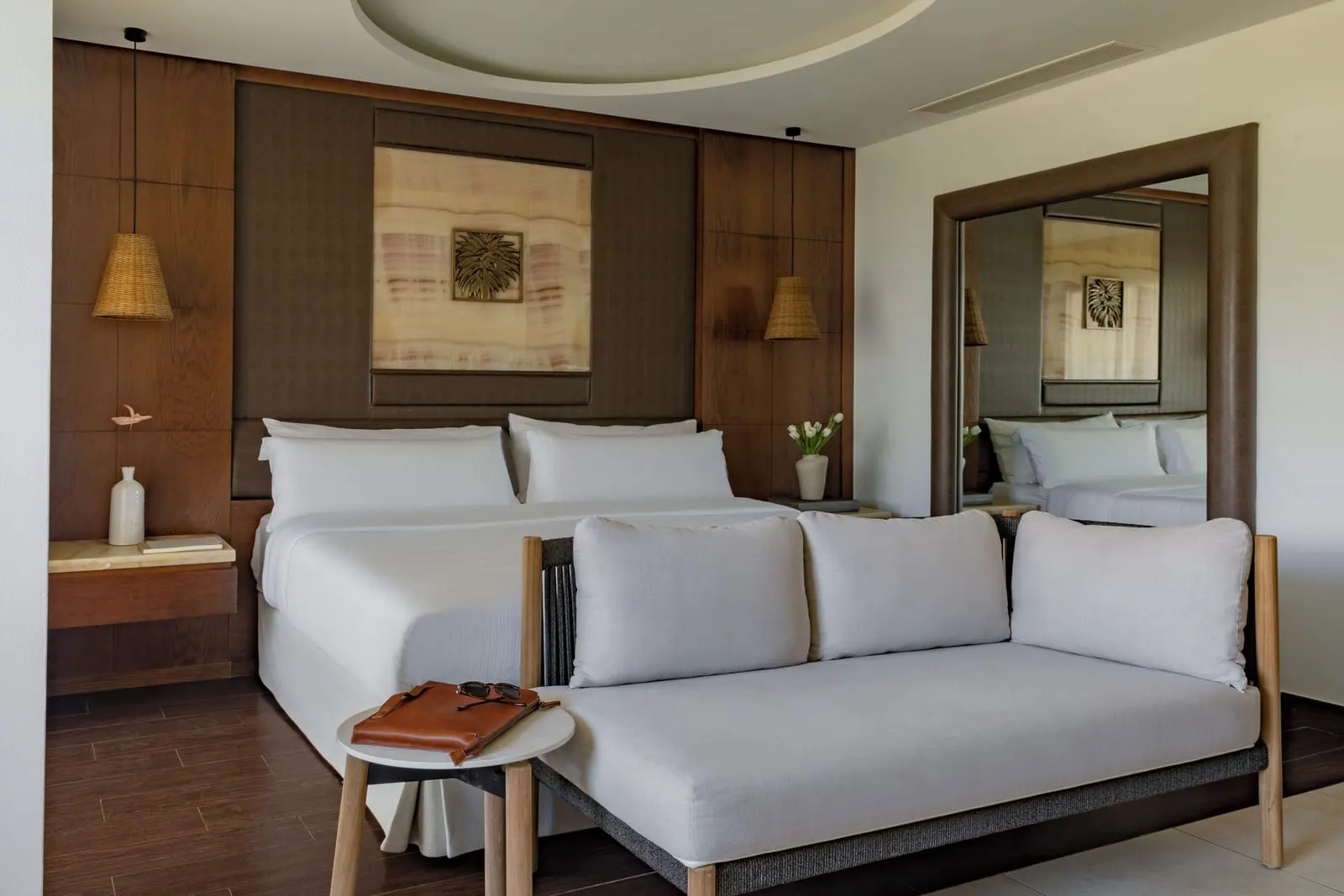RedLevel Junior Suite Private Garden at Gran Meliá Palacio de Isora: the bed and a daybed against a wood-panelled wall