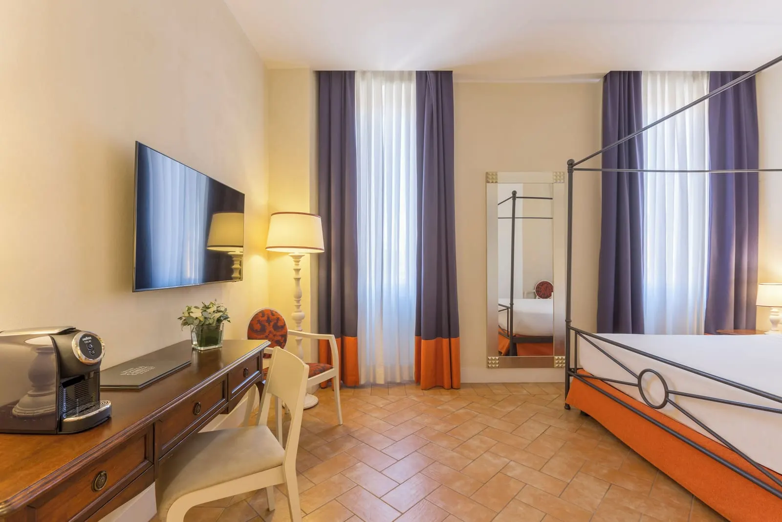 Superior Room at Donna Camilla Savelli: a four-poster bed, a desk with a coffee machine and a wall TV, curtained windows